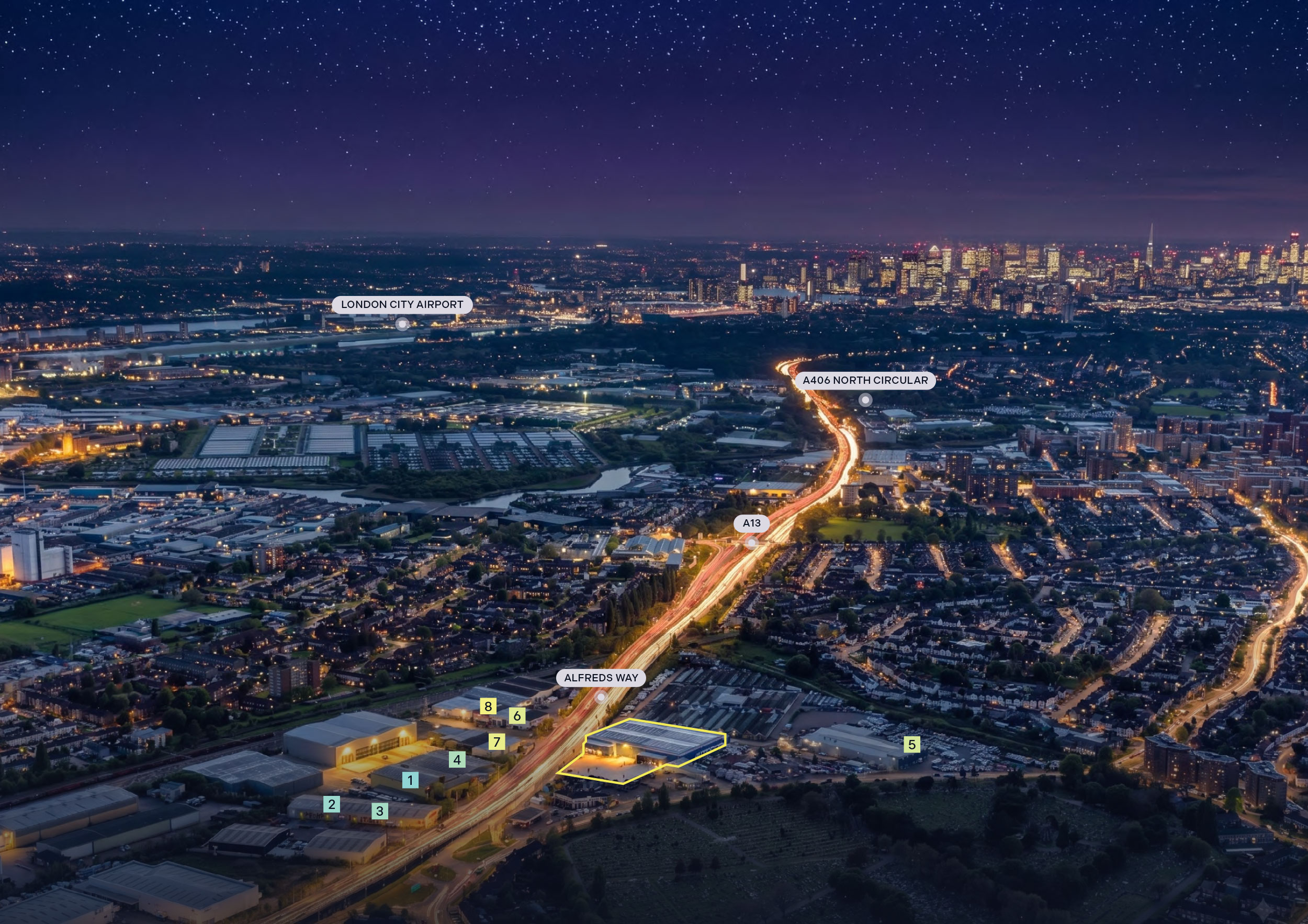 Night aerial looking west over Helix 50 on Alfreds Way, Barking, with the A13, the A406 North Circular, London City Airport and the City of London beyond